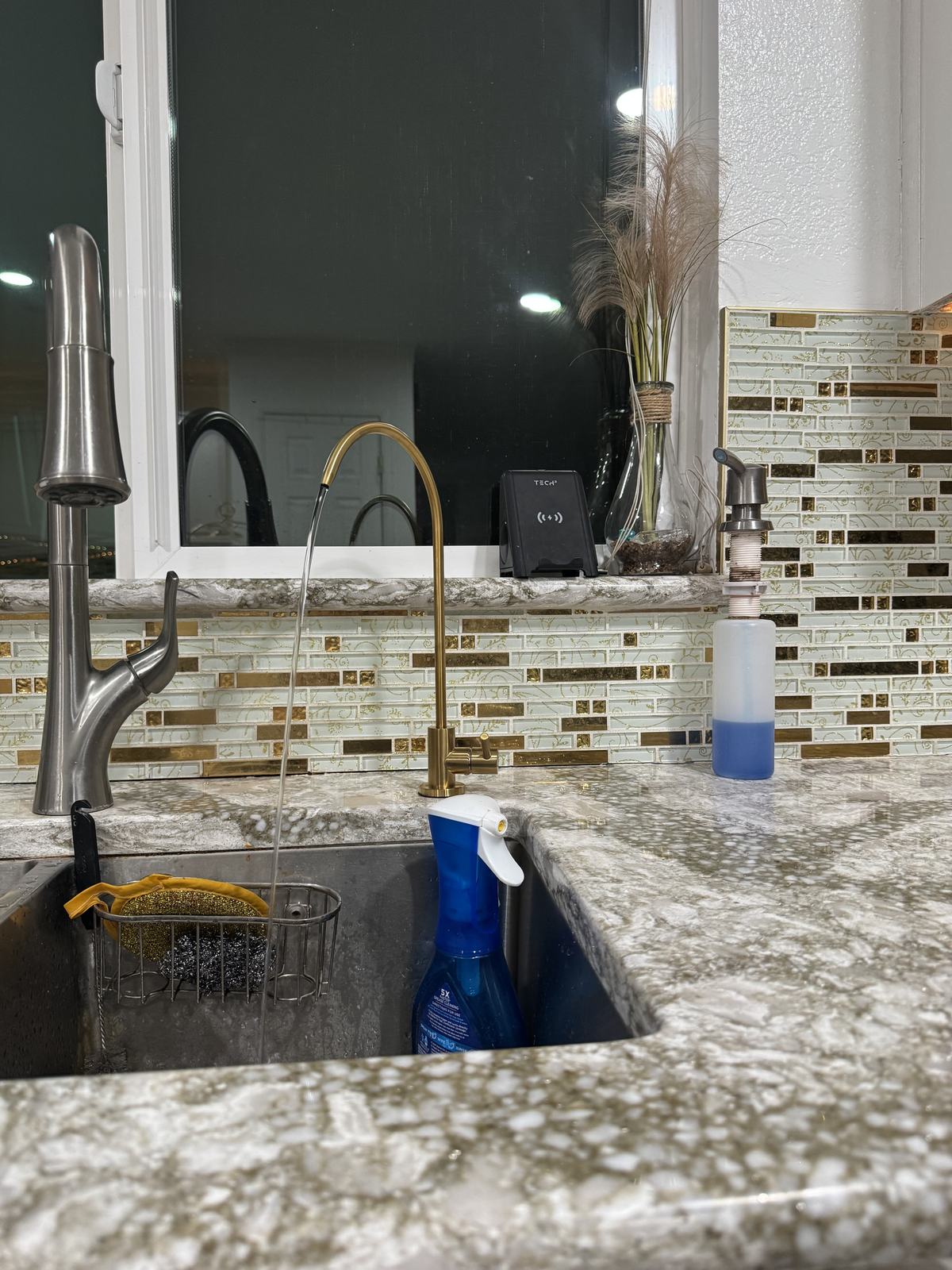 Gold reverse osmosis drinking water faucet installed by Val Water Co at a San Diego kitchen sink