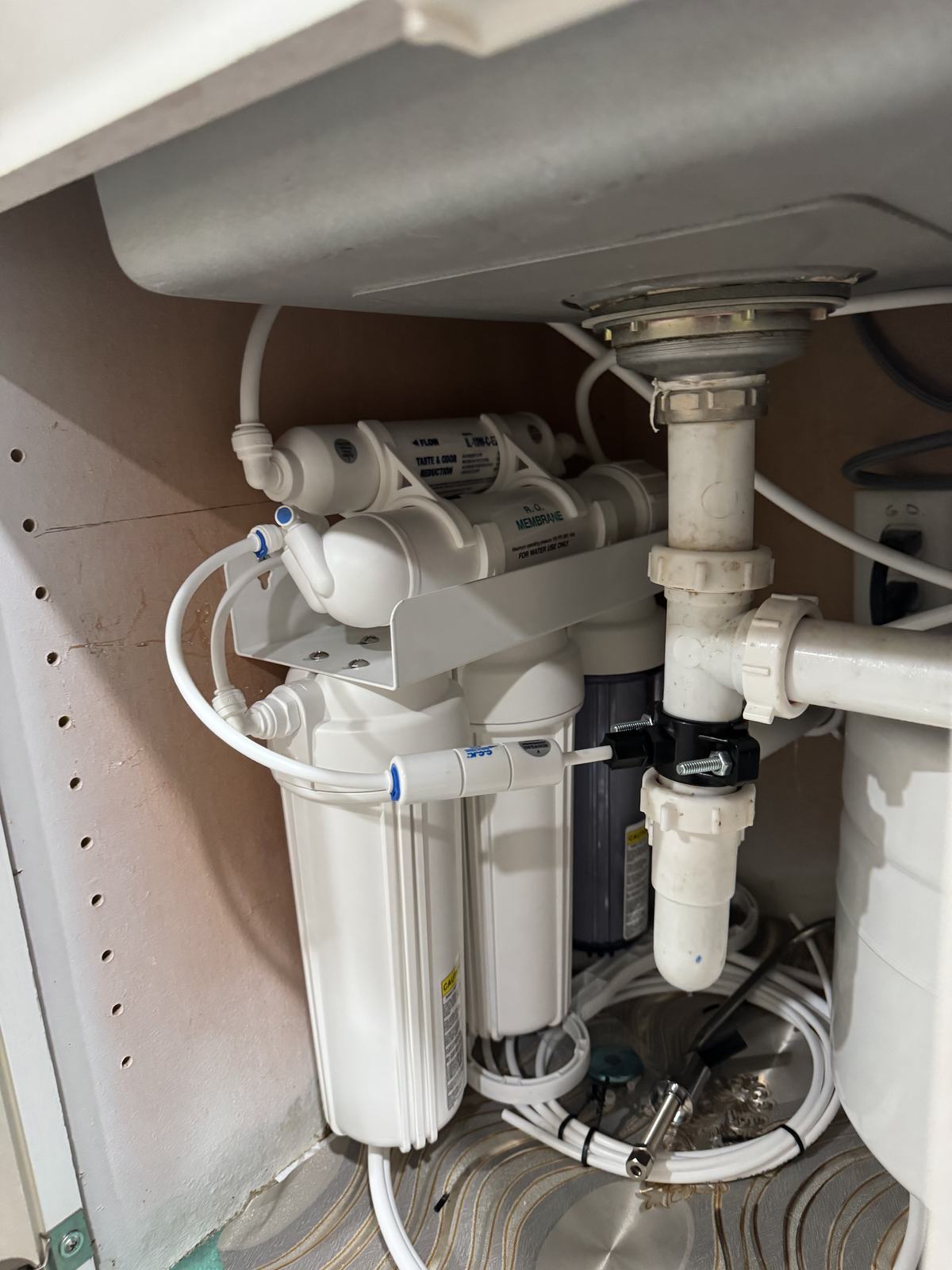 Under-sink reverse osmosis tank system professionally installed and secured by Val Water Co